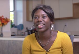 Young Black woman smiling during her interview on INCLUDEnyc's Project Possibility program